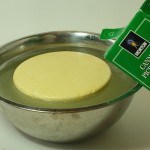 canning salt being poured into bowl with cheese floating in it