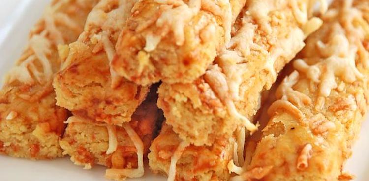 Pyramid of Indonesian cheese sticks, known as Kastengel on a square plate