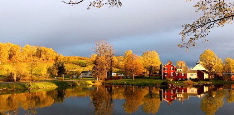 Consider Bardwell farm next to a clear, reflective lake on a spring day