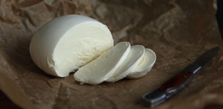 Chapel Hill Creamery's Fresh mozzarella, sliced and on brown paper next to knife