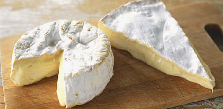 camembert and brie wedge side by side on cheese board