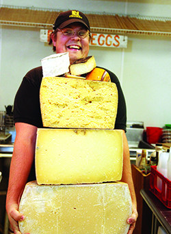 A man holds a LOT of cheese