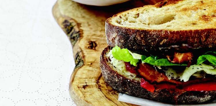 Grilled sandwich with roasted bell pepper, cheese, lettuce, and tomato