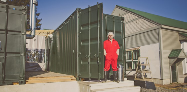 Brian Civitello stands outsides of one of his cheesemaking pods for Mystic Cheese