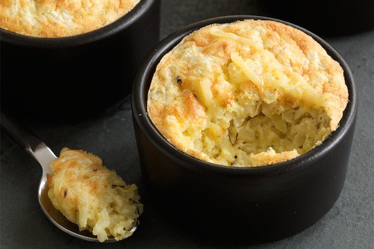 mini cheddar risotto soufflés in black cups