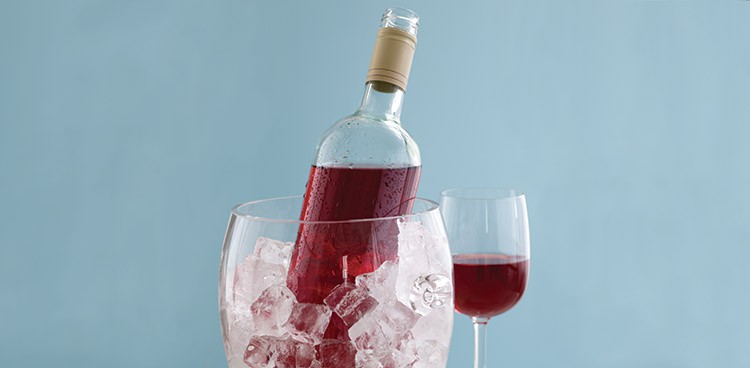 high acid red wine being chilled in a bucket of ice