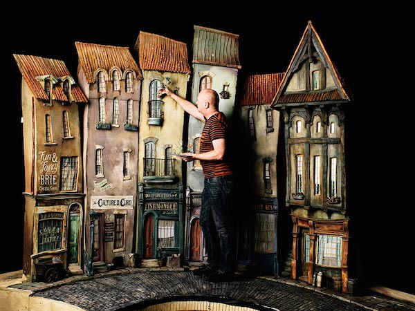 Art director Curt Enderle adjusting some of the buildings of Cheesebridge on the movie set for the movie The Boxtrolls. | Photo credit: photo by Jose Mandojana via wired.com