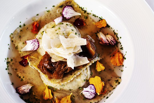 Goat's Milk Ricotta and Fresh Herb Ravioli with Parmigiano Reggiano Broth and Edible Blossoms