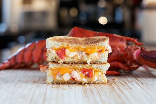 Lobster grilled cheese with a whole cooked lobster behind it