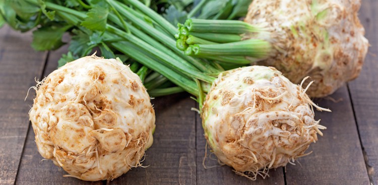 Celeriac bulbs on a wooden background
