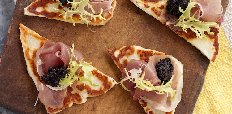 Halloumi Crostini with Kalamata Olive Paste, Prosciutto, Frisée, and Lemon Zest