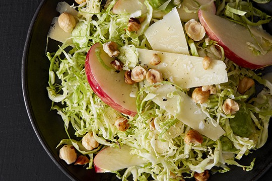 Shaved Brussels sprout salad with hazelnuts, cheddar, and apples