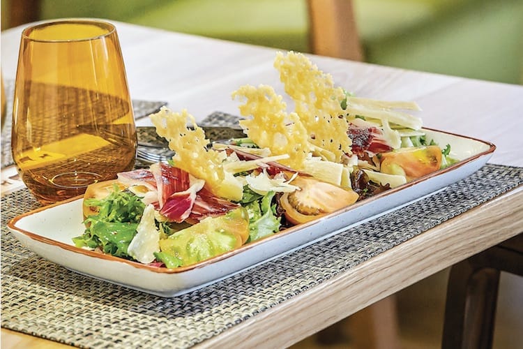 lettuce salad topped with jamón ibérico and crispy parmigiano reggiano